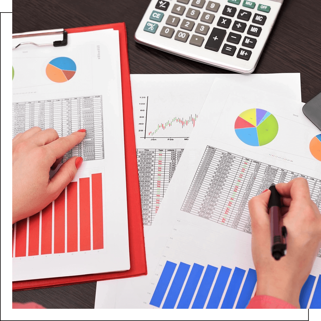 Two people analyzing financial charts and data with a calculator and clipboard.